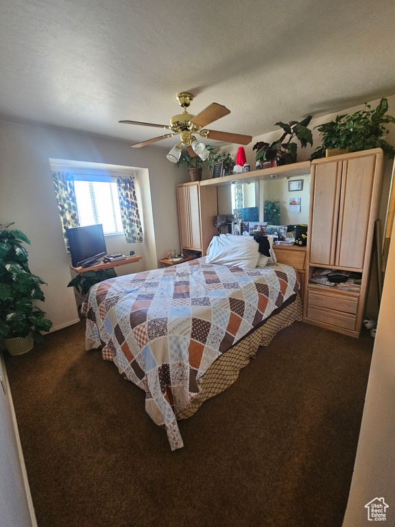 Carpeted bedroom featuring ceiling fan