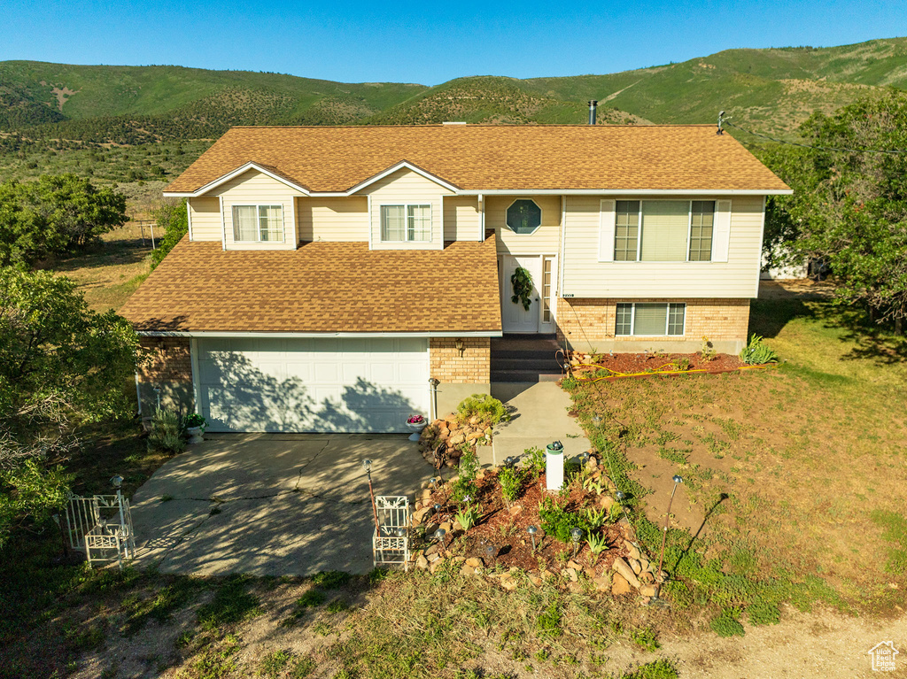 Bi-level home featuring a mountain view and a garage