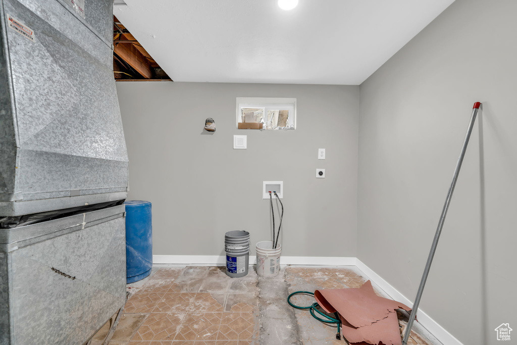 Clothes washing area featuring electric dryer hookup, washer hookup, and tile patterned floors