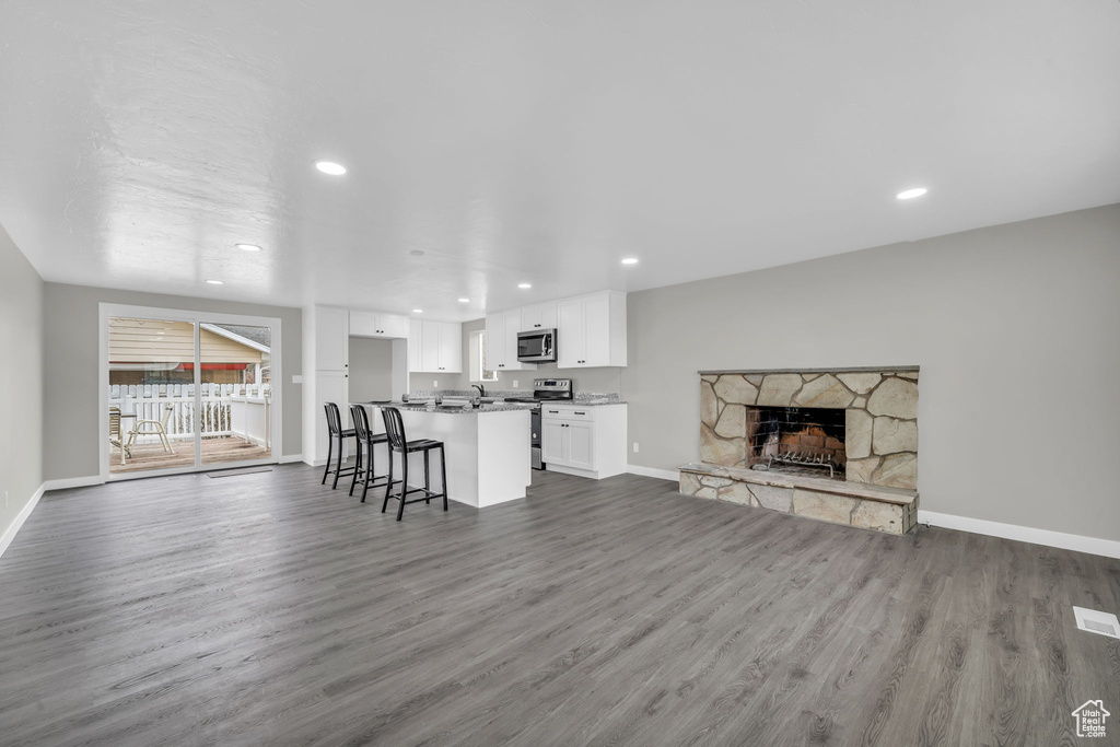 Living room with a fireplace and hardwood / wood-style flooring