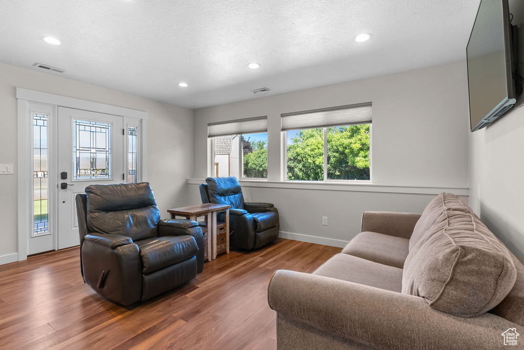 Living room with hardwood / wood-style floors and a wealth of natural light