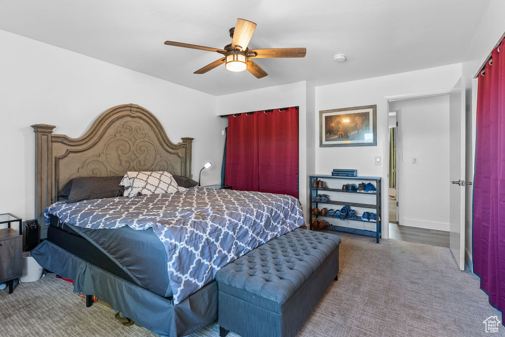 Bedroom with ceiling fan and wood-type flooring