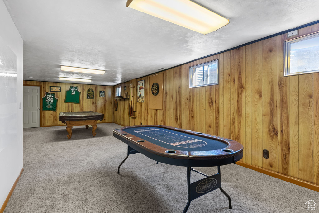 Game room featuring pool table, carpet, and wooden walls