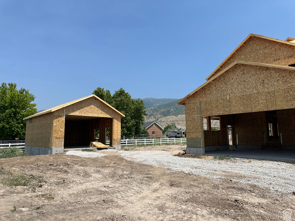 View of horse barn featuring a mountain view