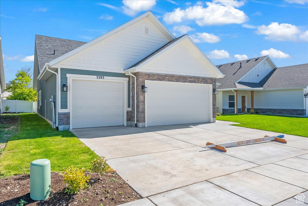 View of front of home featuring a garage and a front lawn