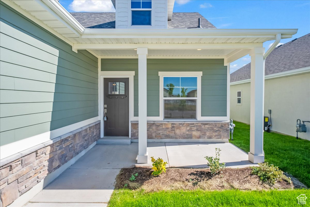 View of exterior entry with covered porch