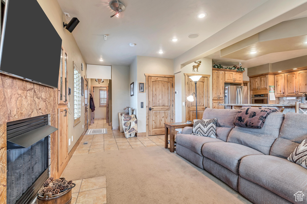 Living room featuring a fireplace and light colored carpet