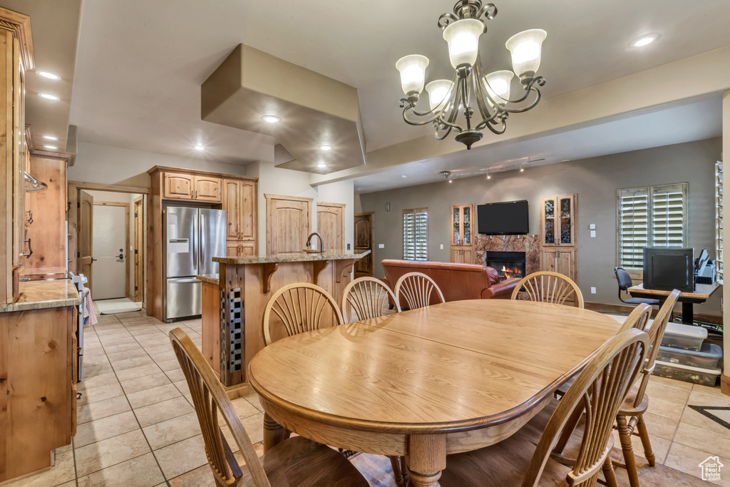 Dining space featuring an inviting chandelier and light tile patterned floors