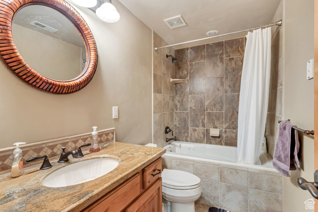 Full bathroom featuring vanity, toilet, and shower / bath combo