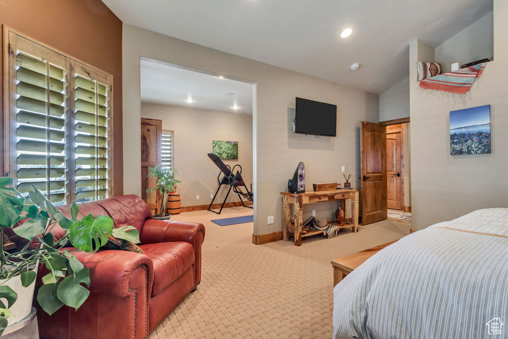 Bedroom featuring carpet floors and vaulted ceiling