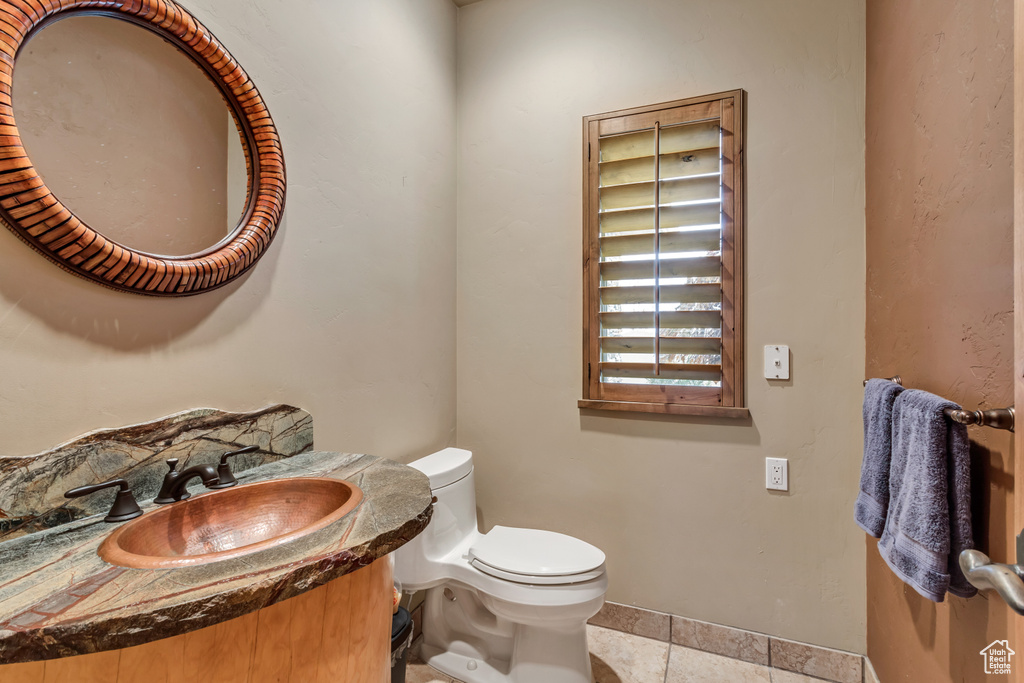 Bathroom with tile patterned flooring, toilet, and vanity