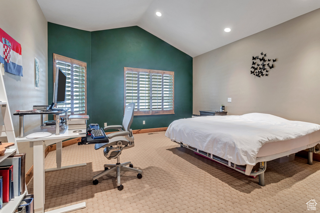 Carpeted bedroom featuring lofted ceiling