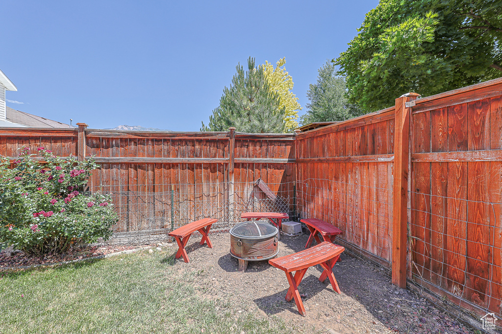 View of yard with an outdoor fire pit