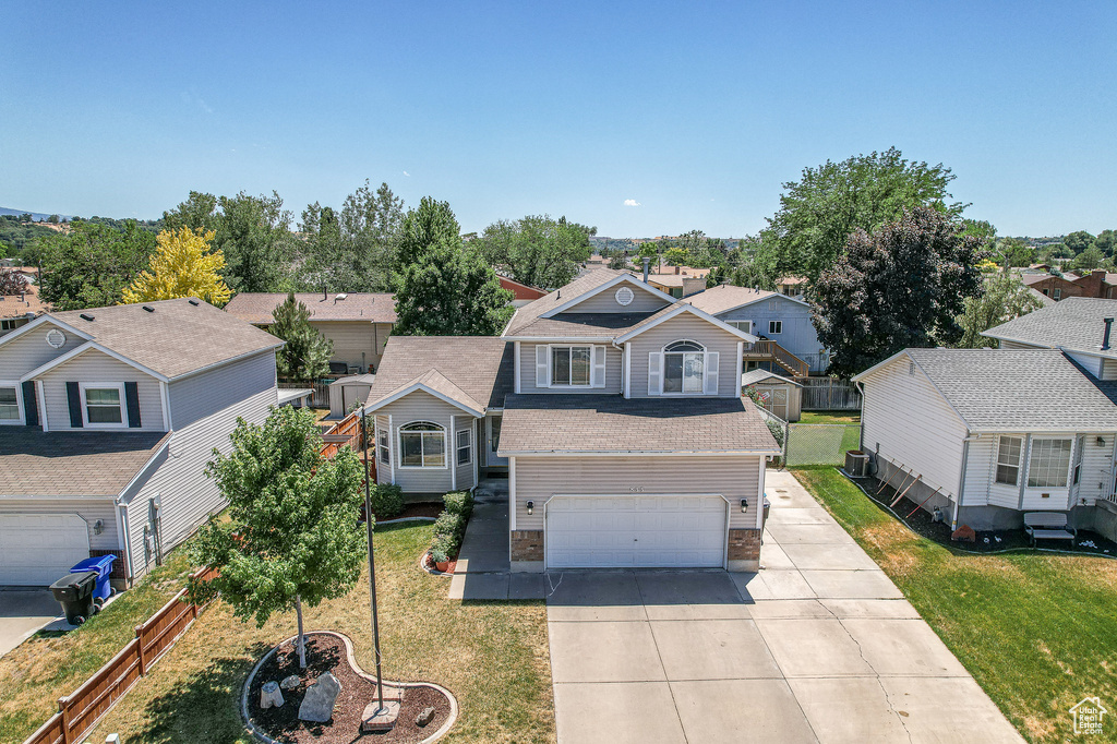 View of front of house featuring a garage and a front lawn