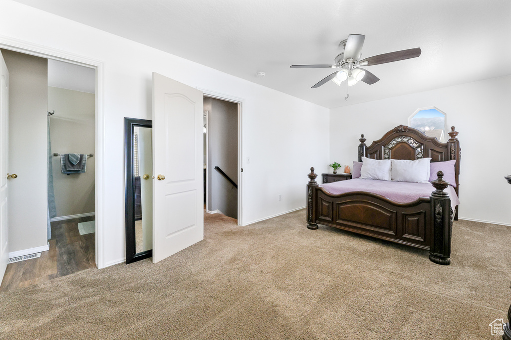 Carpeted bedroom with ceiling fan