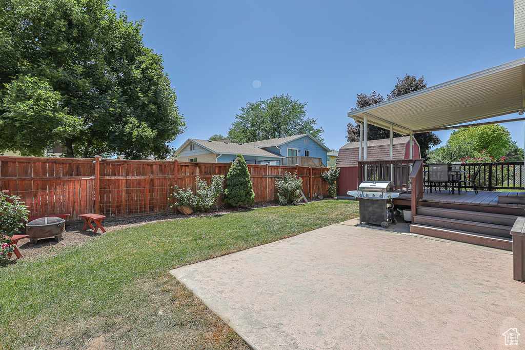 View of yard with a patio, a deck, and a fire pit