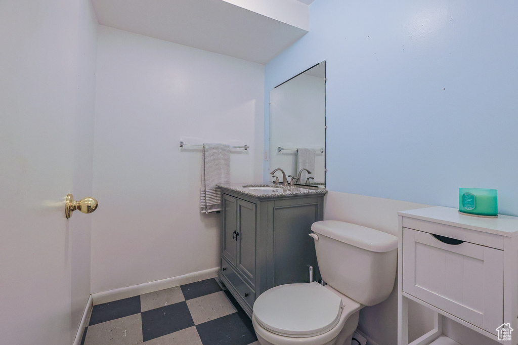 Bathroom with vanity, tile patterned flooring, and toilet