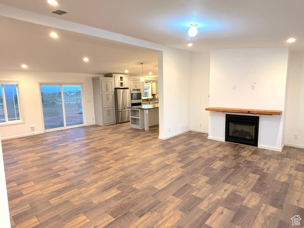 Unfurnished living room featuring wood-type flooring