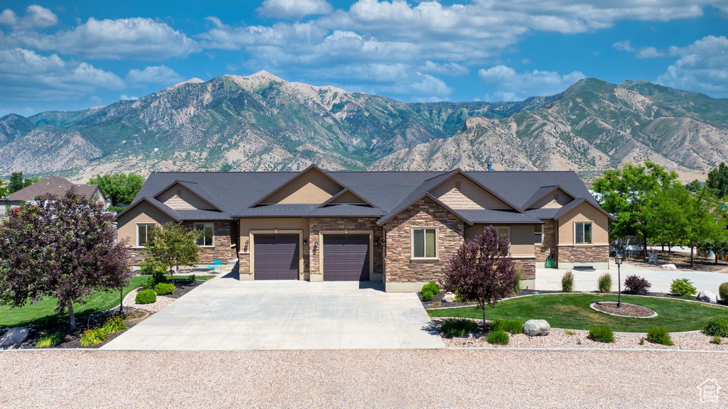 Craftsman inspired home with a mountain view and a front yard