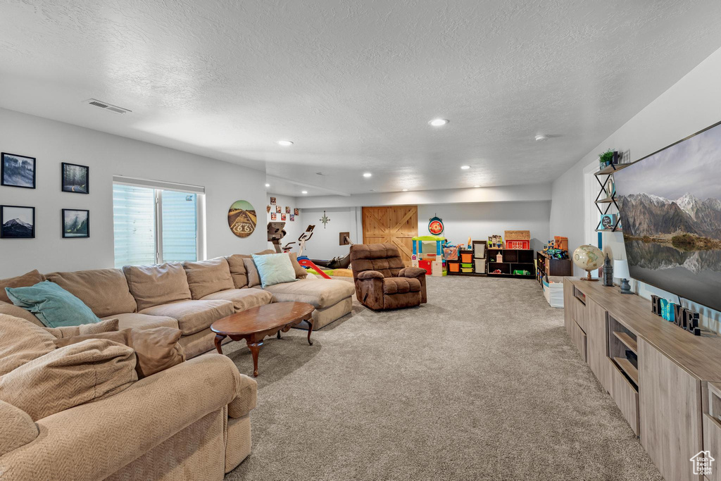 Living room with light carpet and a textured ceiling