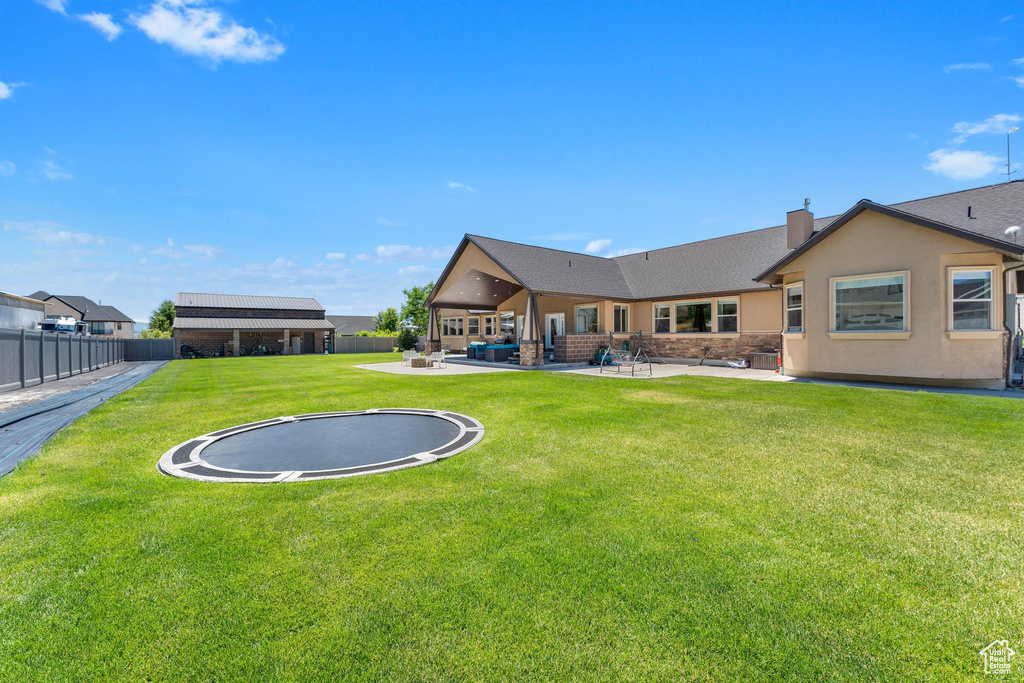 Exterior space featuring a patio and a yard