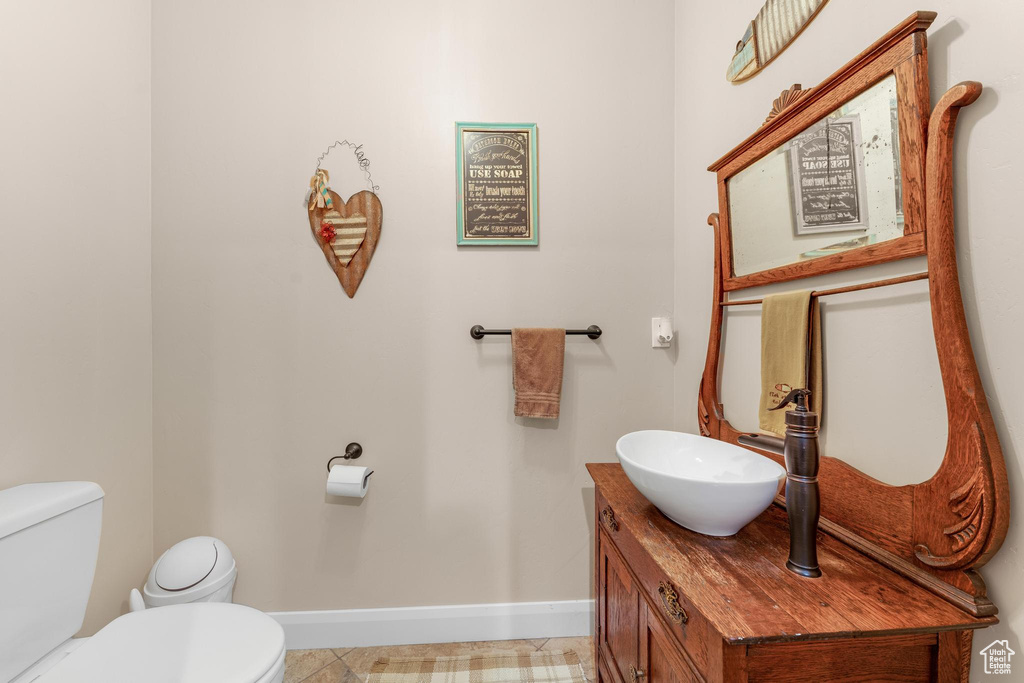 Bathroom featuring vanity, toilet, and tile patterned floors