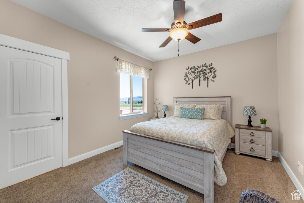 Bedroom featuring carpet floors and ceiling fan