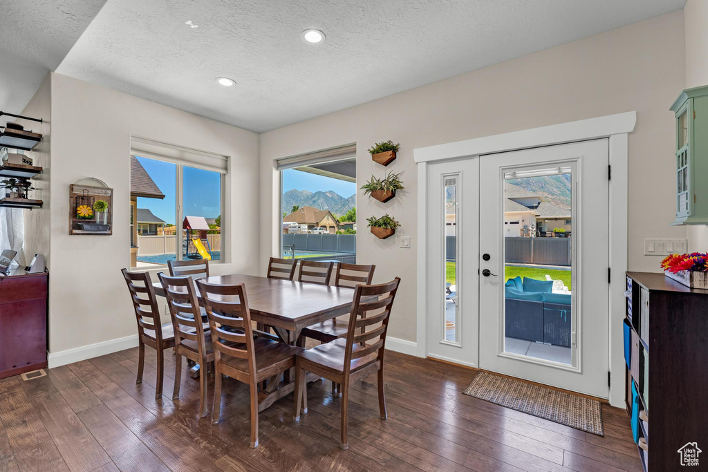 Dining room featuring dark hardwood / wood-style flooring and a textured ceiling