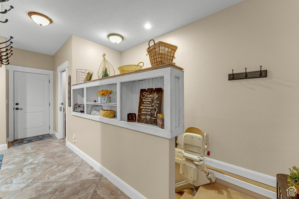 Hallway featuring light tile patterned flooring