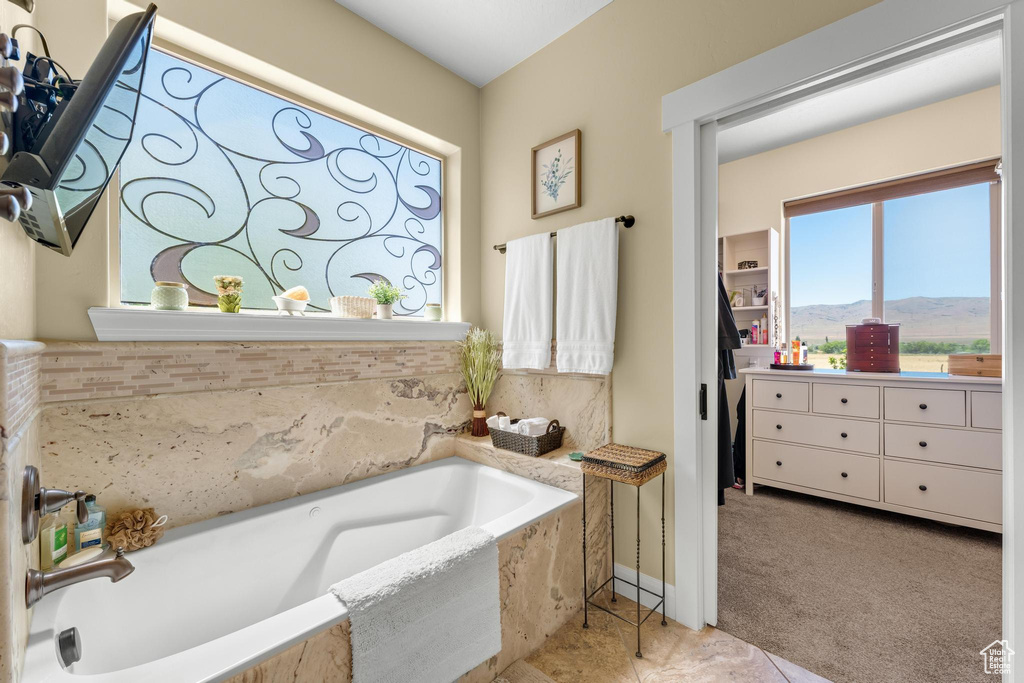 Bathroom featuring a washtub and tile patterned floors