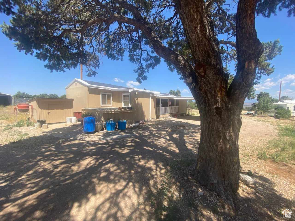 View of front of home with a storage unit