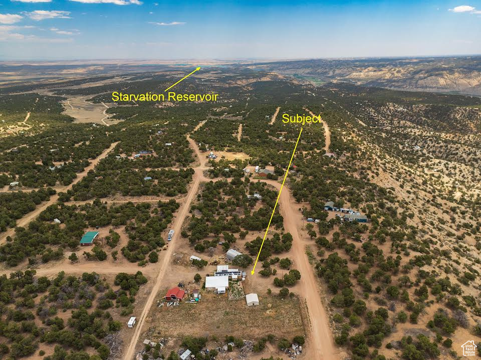 Birds eye view of property with a rural view