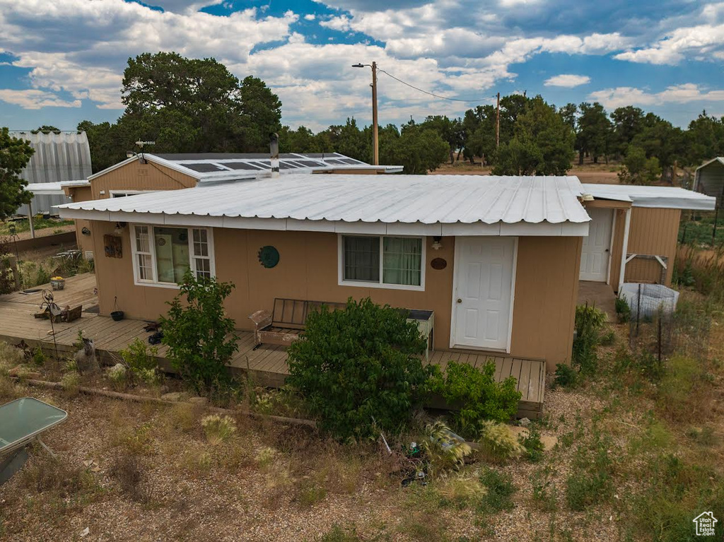 View of front of home with a wooden deck