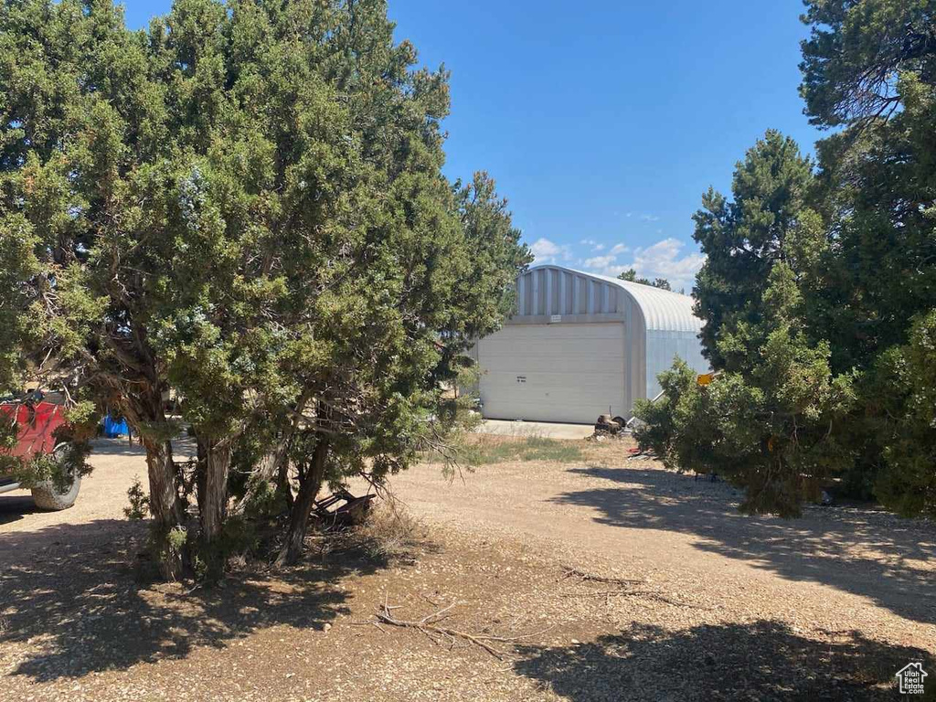 View of yard with a garage and an outdoor structure