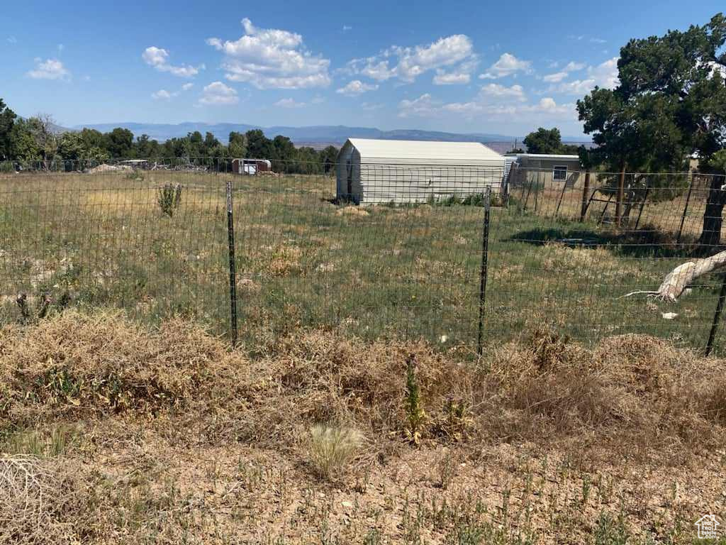 View of yard with an outbuilding and a rural view