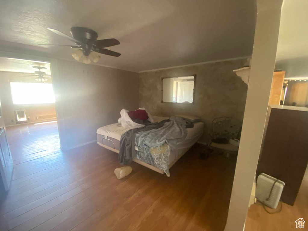 Bedroom featuring ceiling fan and hardwood / wood-style flooring