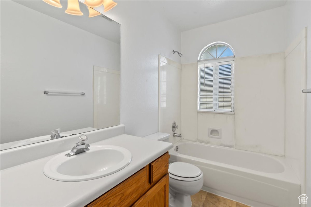 Full bathroom with vanity, bathtub / shower combination, toilet, and tile patterned floors