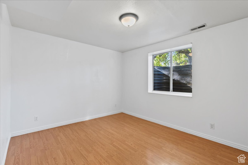 Unfurnished room with light wood-type flooring