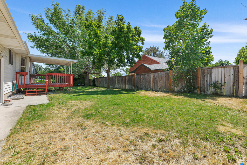 View of yard featuring a wooden deck