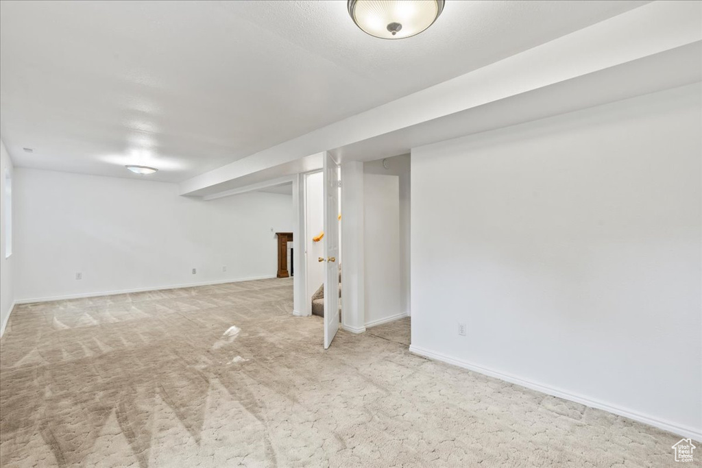 Basement with light carpet