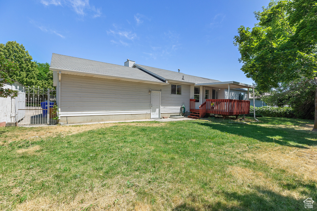 Rear view of house with a lawn