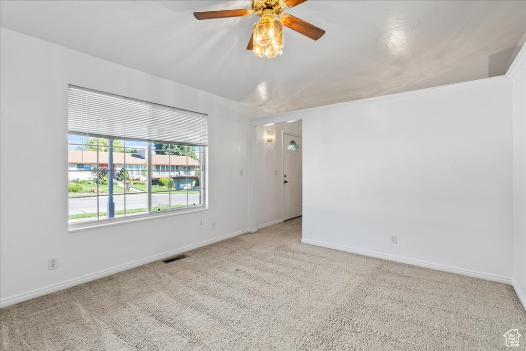 Spare room with light carpet and ceiling fan