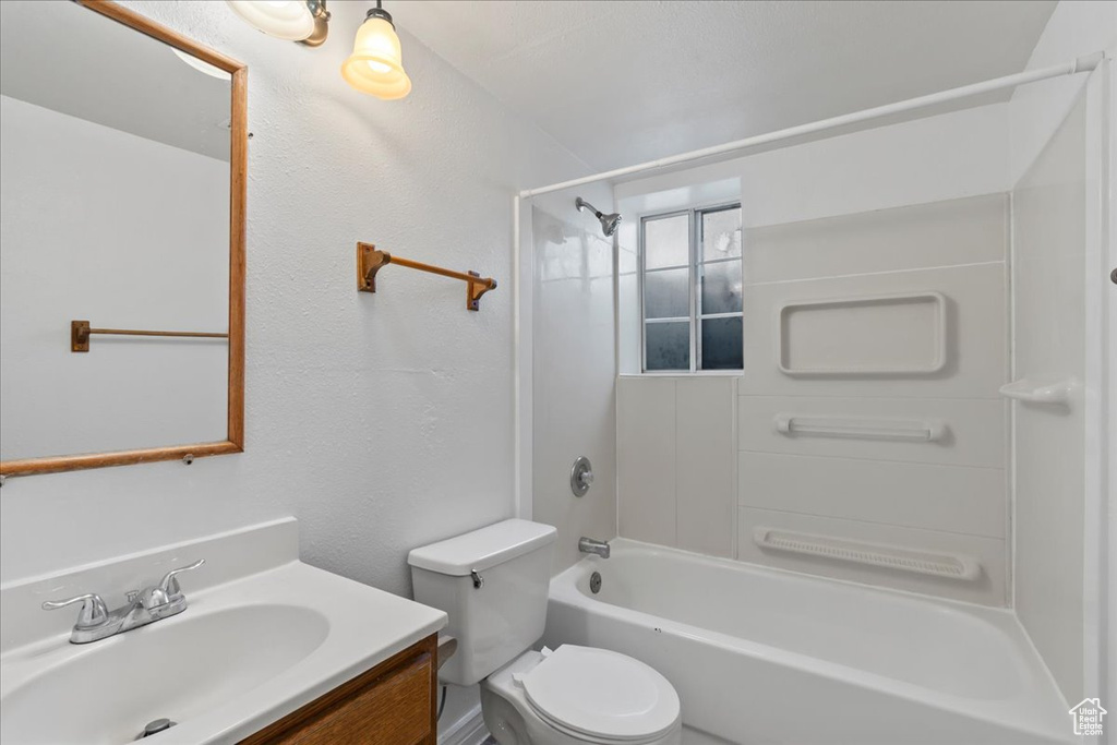 Full bathroom featuring vanity, toilet, and shower / bath combination