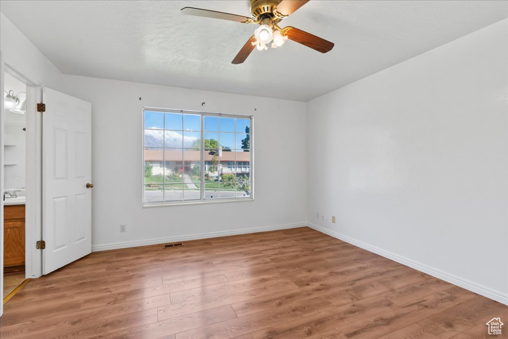 Unfurnished bedroom with hardwood / wood-style floors and ceiling fan