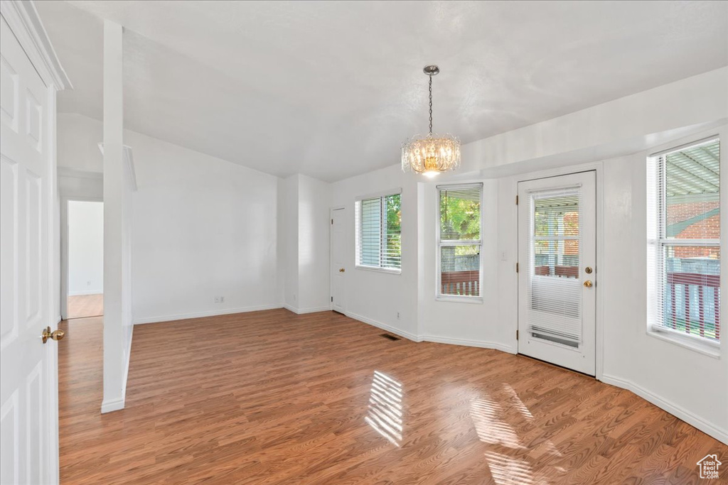 Interior space featuring a notable chandelier and light wood-type flooring