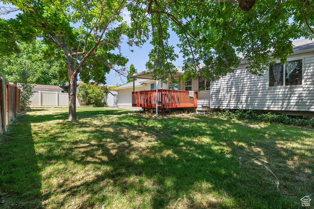 View of yard featuring a storage shed and a wooden deck