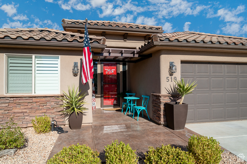 Doorway to property featuring a garage