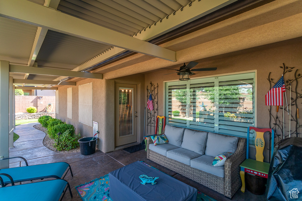 View of patio featuring an outdoor living space and ceiling fan