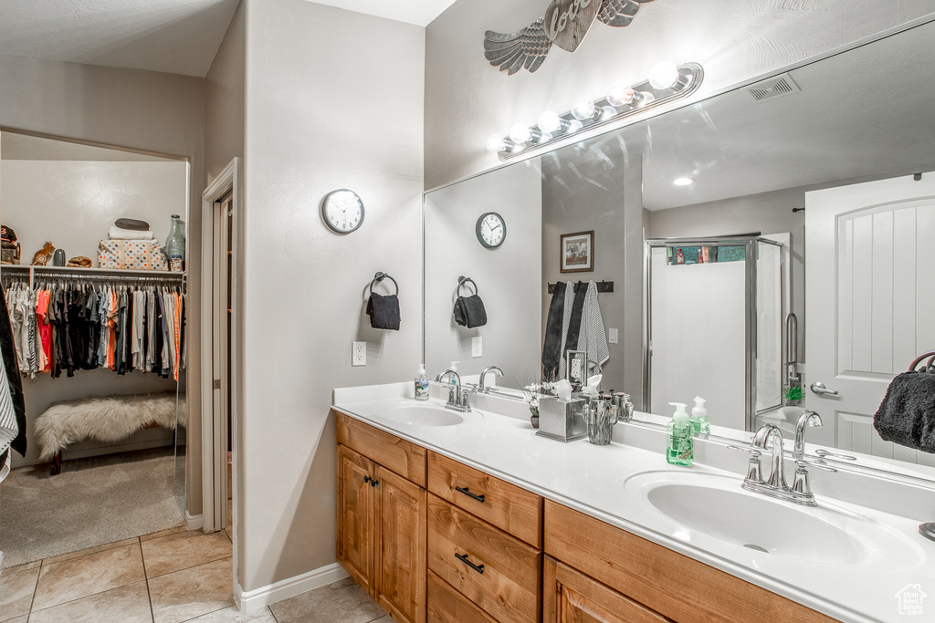 Bathroom with tile patterned flooring and dual bowl vanity