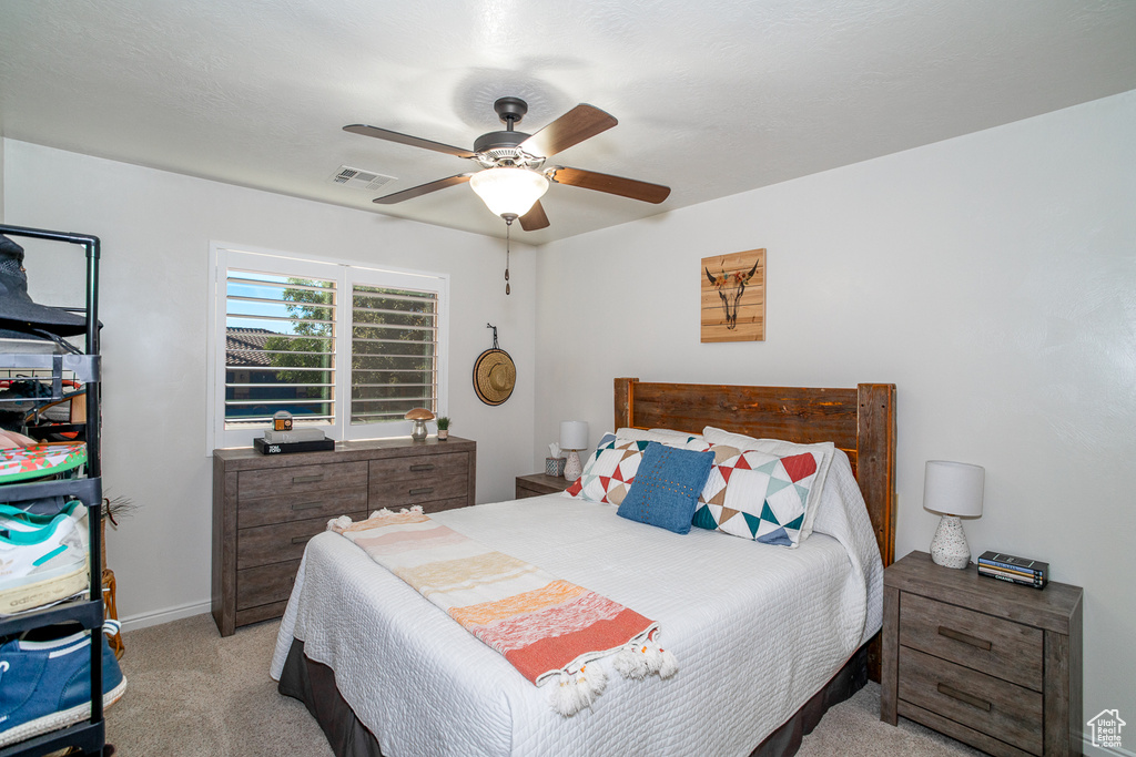 Carpeted bedroom with ceiling fan